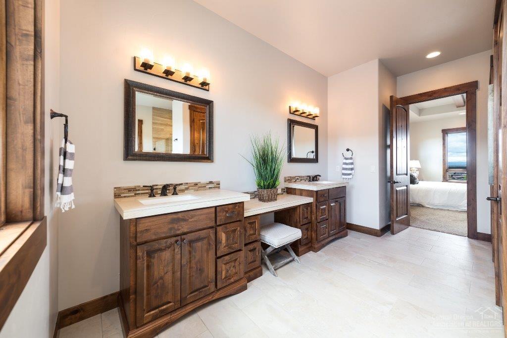 16137 Southwest Brasada Rnch Road Powell Butte, OR 97753 - Photo 12 of 25 a spacious bathroom with a double vanity sink a mirror and a bathtub