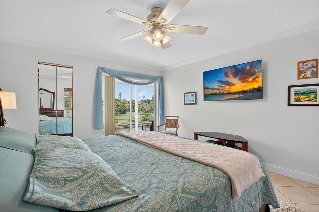 3551 Inverrary Drive, Unit 312 Lauderhill, FL 33319 - Photo 23 of 42 a bedroom with a bed and a painting on the wall