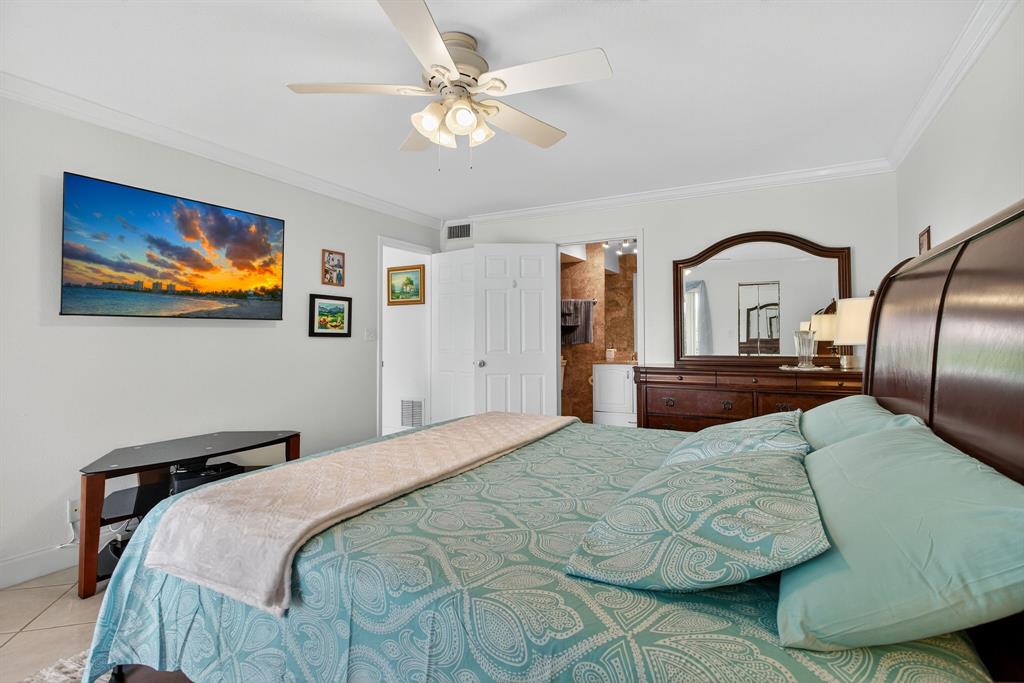 3551 Inverrary Drive, Unit 312 Lauderhill, FL 33319 - Photo 24 of 42 a bedroom with a bed and ceiling fan