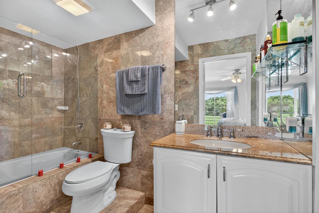 3551 Inverrary Drive, Unit 312 Lauderhill, FL 33319 - Photo 26 of 42 a bathroom with a toilet sink and mirror