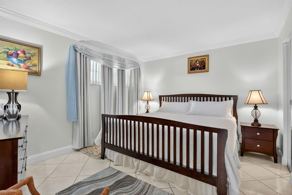 3551 Inverrary Drive, Unit 312 Lauderhill, FL 33319 - Photo 9 of 42 a bedroom with bed and a window