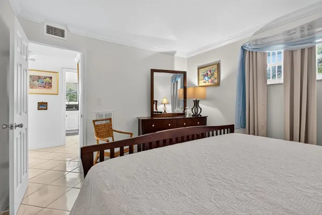 a bedroom with a bed and a night stand