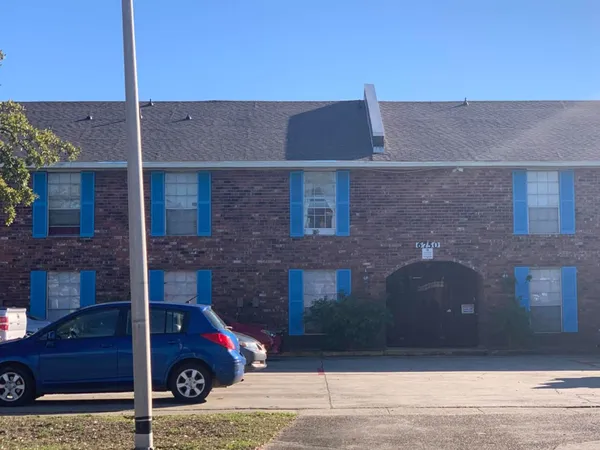 a front view of a house with parking space