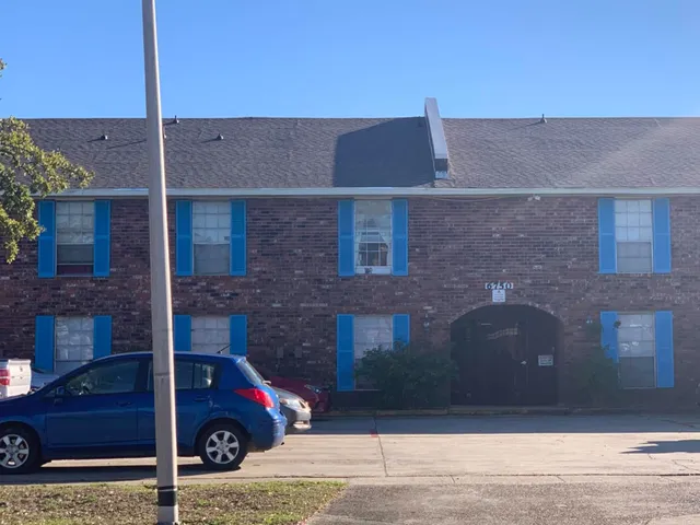 a front view of a house with parking space