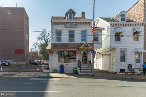 a front view of a building and car parked