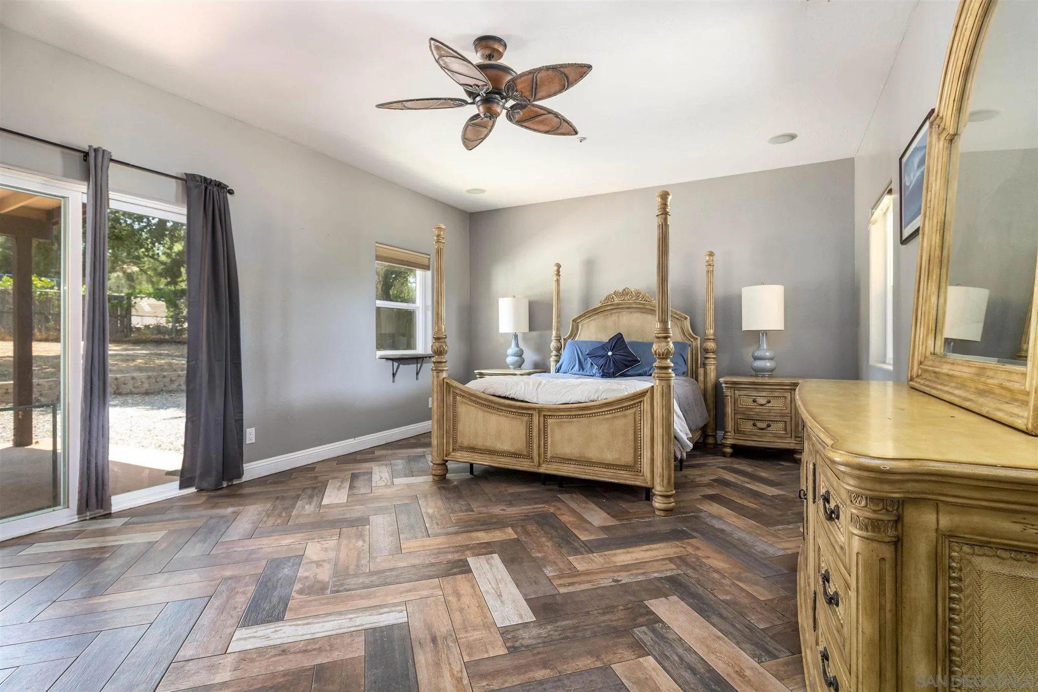 19139 Split Rock Road Ramona, CA 92065 - Photo 13 of 29 a spacious bedroom with a bed a dresser and a large window