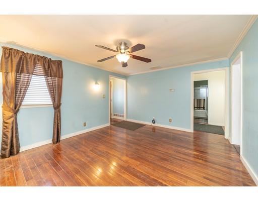 17 Eldridge Street Chicopee, MA 01013 - Photo 5 of 30 a view of an empty room with chandelier fan and wooden floor