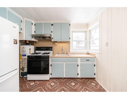 17 Eldridge Street Chicopee, MA 01013 - Photo 9 of 30 a kitchen with white cabinets and appliances