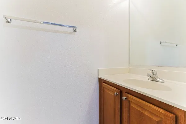 a bathroom with a sink vanity and a mirror
