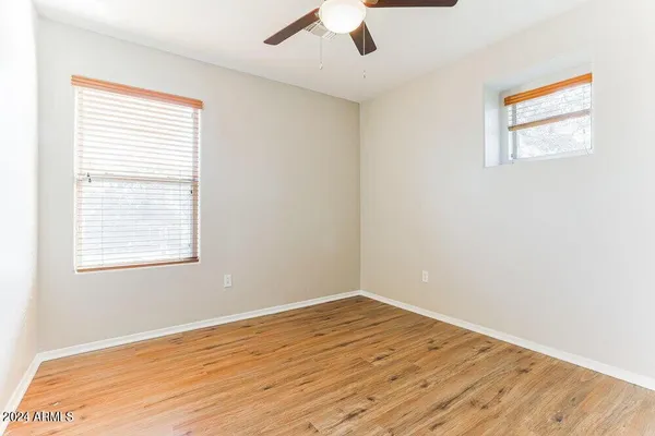 a view of empty room with wooden floor