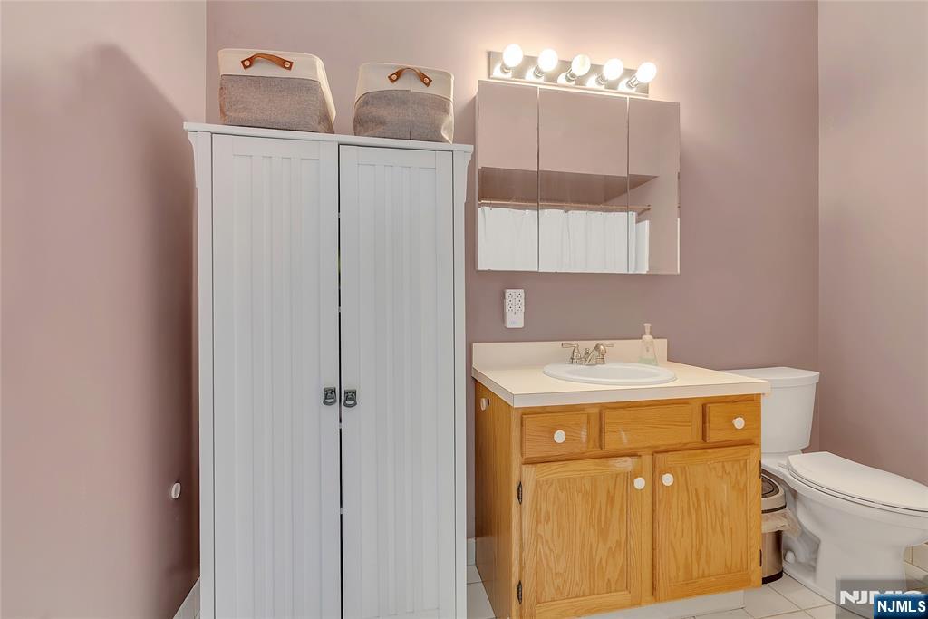5320 Richmond Road West Milford, NJ 07480 - Photo 11 of 20 a bathroom with a sink a toilet and mirror