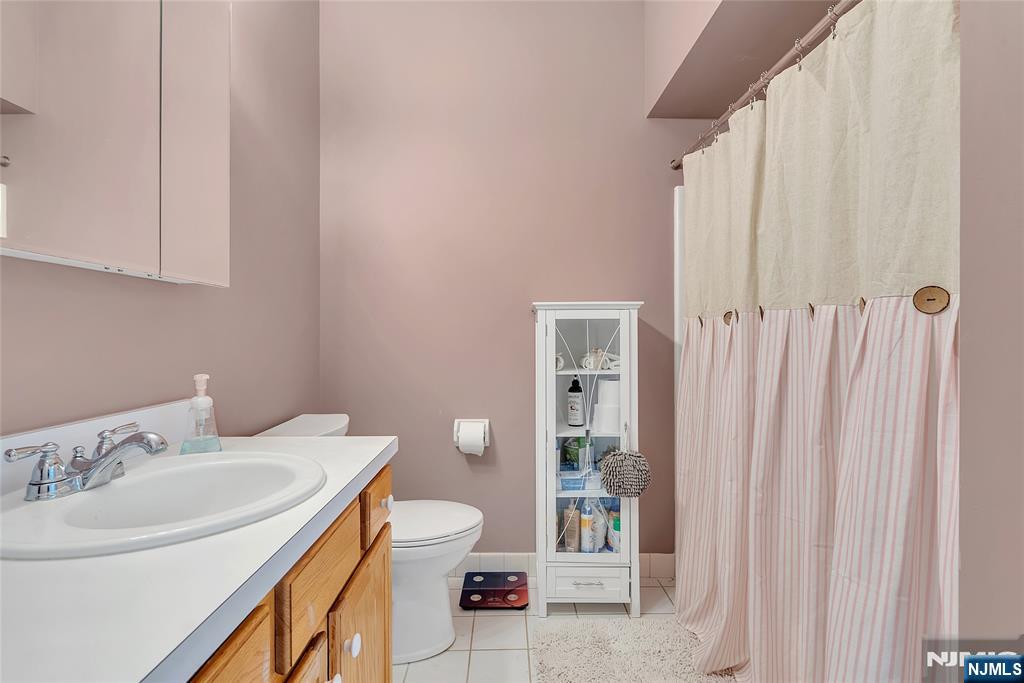 5320 Richmond Road West Milford, NJ 07480 - Photo 12 of 20 a bathroom with a sink a toilet and shower curtain