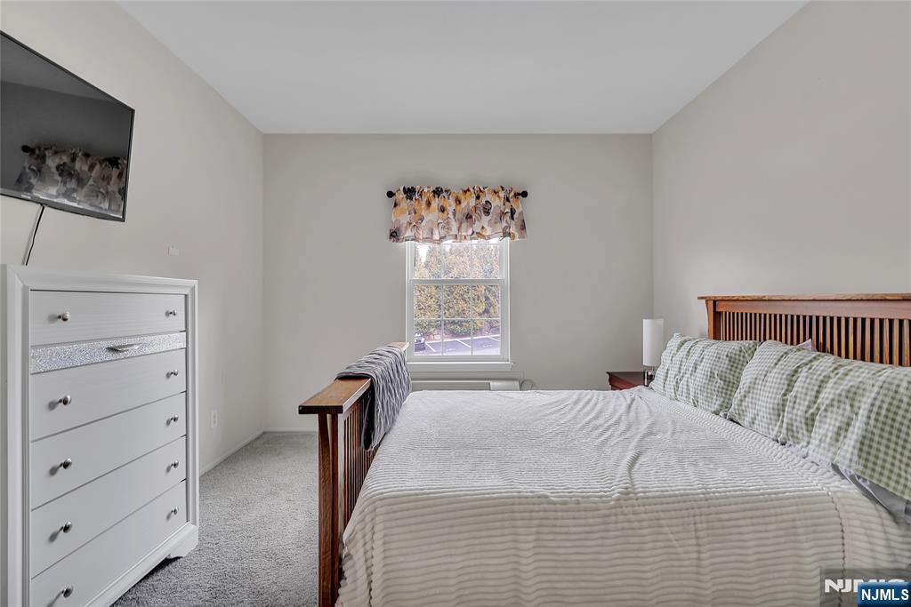5320 Richmond Road West Milford, NJ 07480 - Photo 14 of 20 a bedroom with a bed and a flat tv screen on dresser