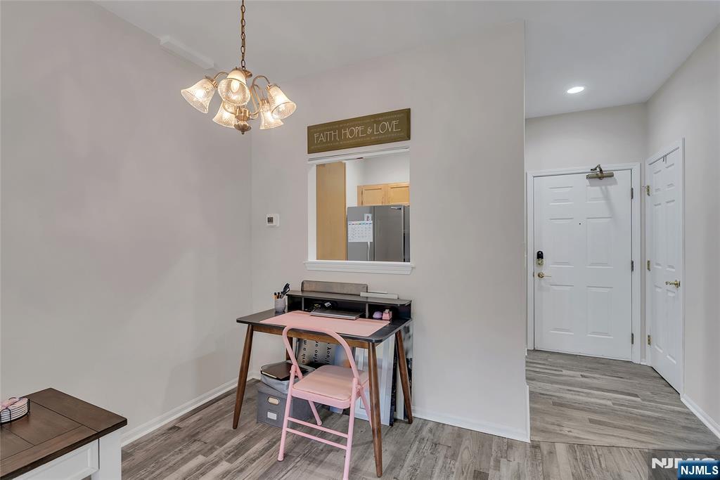5320 Richmond Road West Milford, NJ 07480 - Photo 7 of 20 a dining room with wooden floor a chandelier a wooden table and chairs