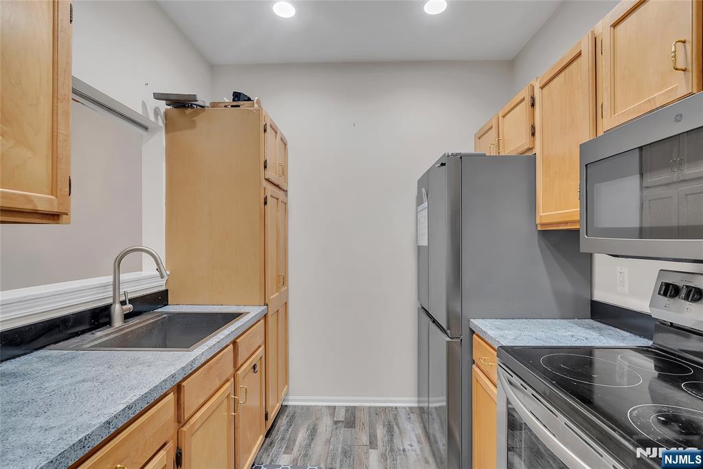 5320 Richmond Road West Milford, NJ 07480 - Photo 8 of 20 a kitchen with stainless steel appliances granite countertop a sink stove and refrigerator
