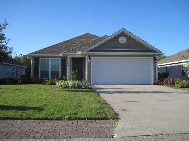 563 Fanny Ann Way Freeport, FL 32439 - Photo 1 of 18 a front view of a house with a yard