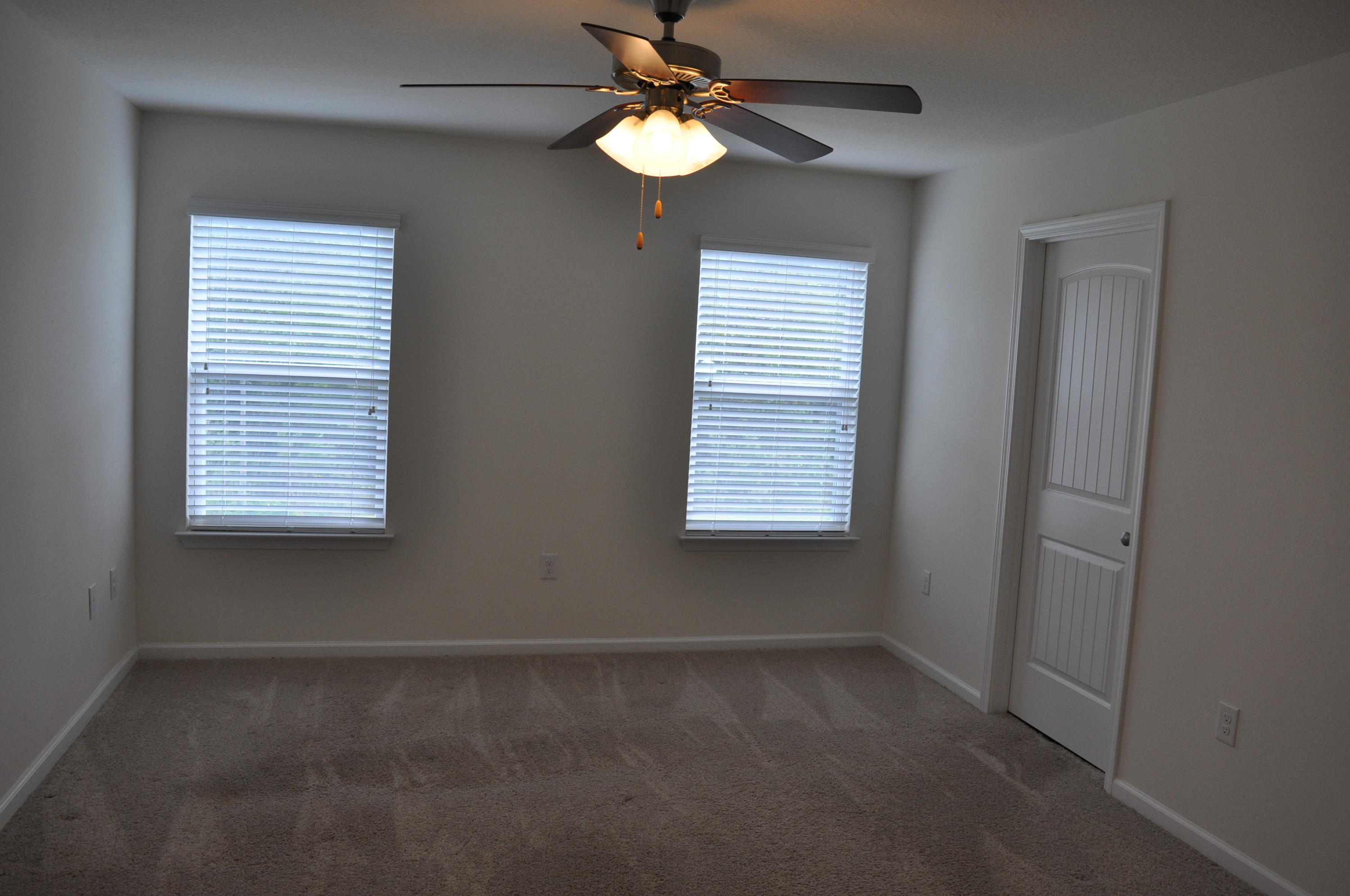 563 Fanny Ann Way Freeport, FL 32439 - Photo 11 of 18 a view of a chandelier fan and windows in an empty room
