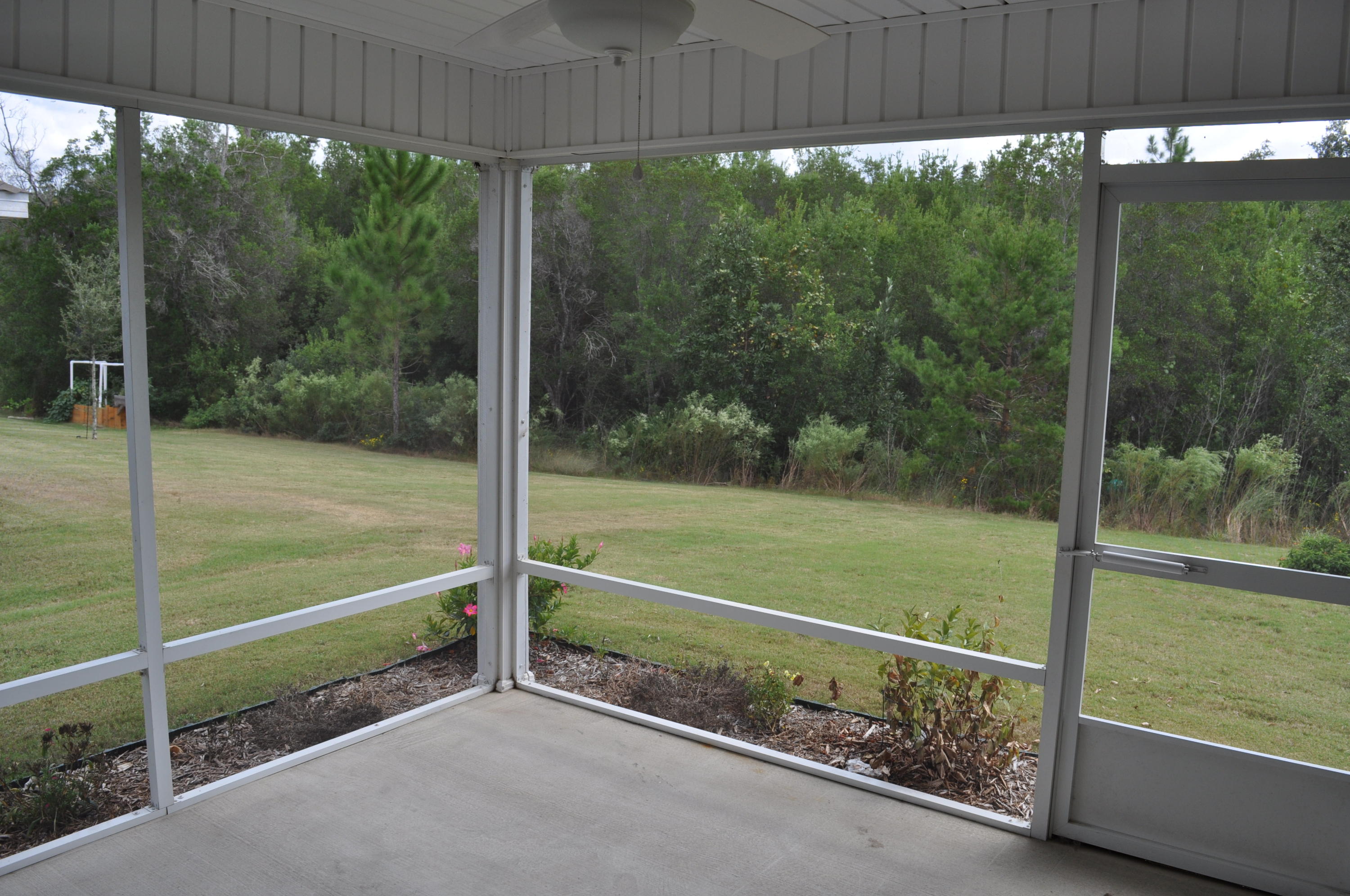 563 Fanny Ann Way Freeport, FL 32439 - Photo 13 of 18 a view of a room with a floor to ceiling window and a small yard