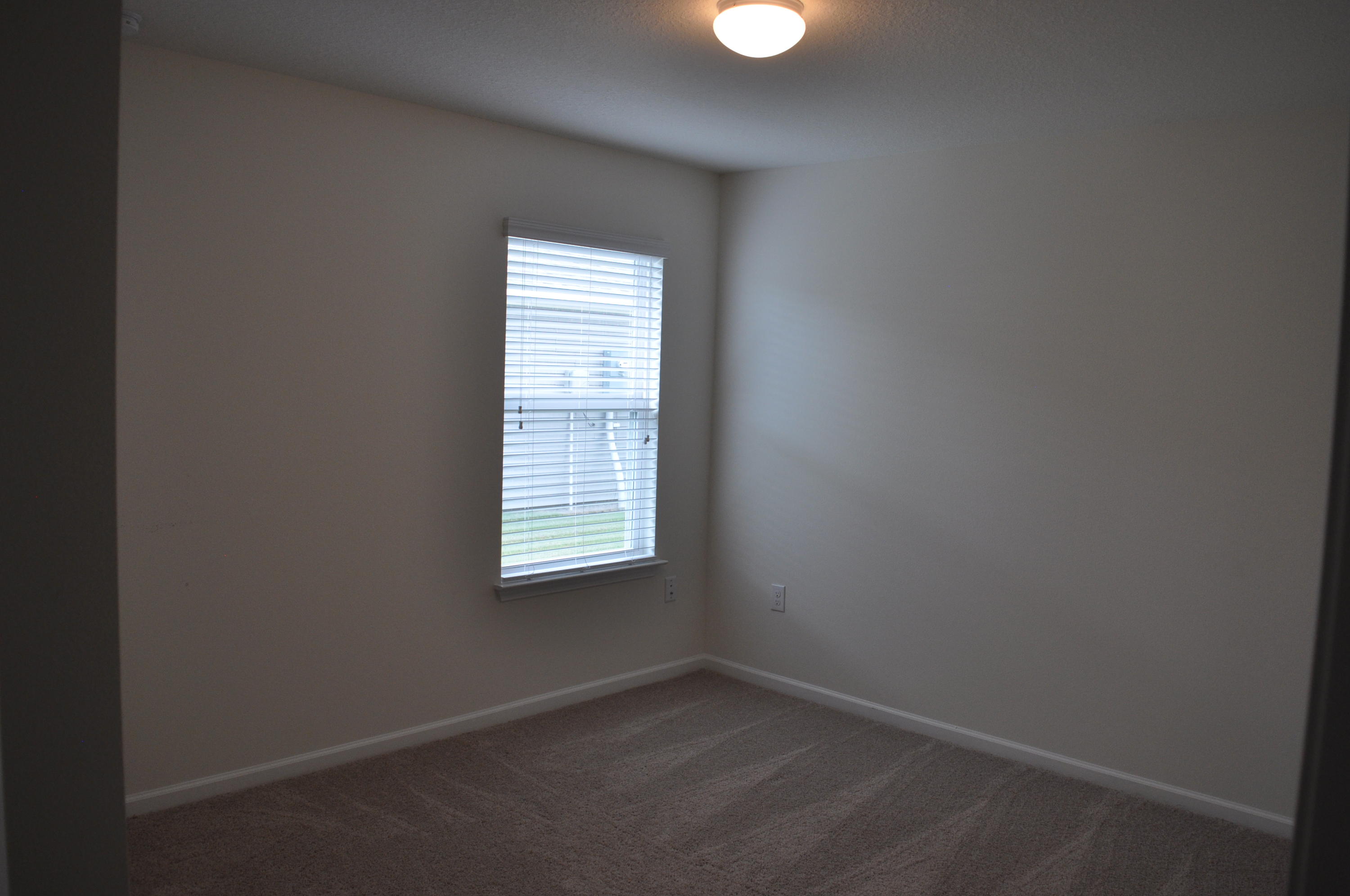 563 Fanny Ann Way Freeport, FL 32439 - Photo 2 of 18 an empty room with a window