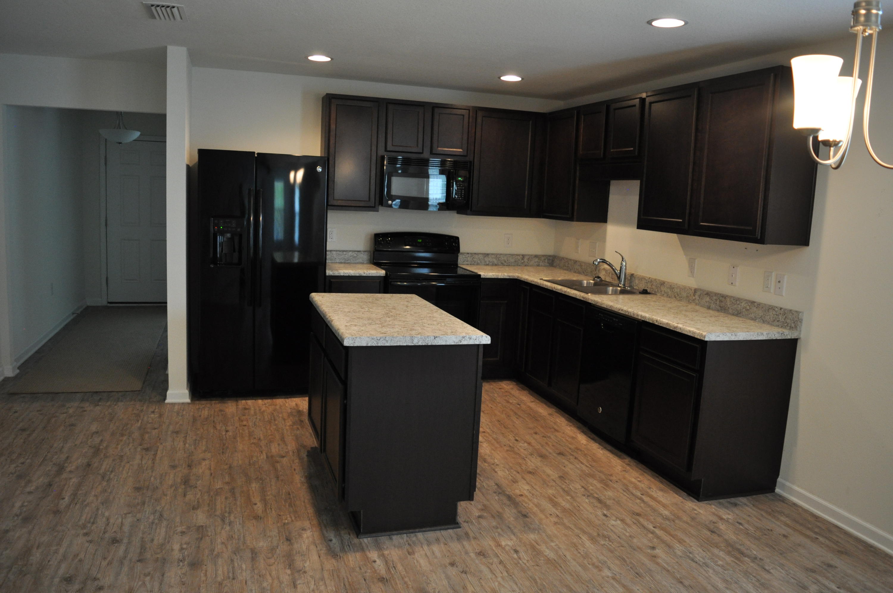 563 Fanny Ann Way Freeport, FL 32439 - Photo 5 of 18 a kitchen with kitchen island granite countertop wooden cabinets a refrigerator and a sink