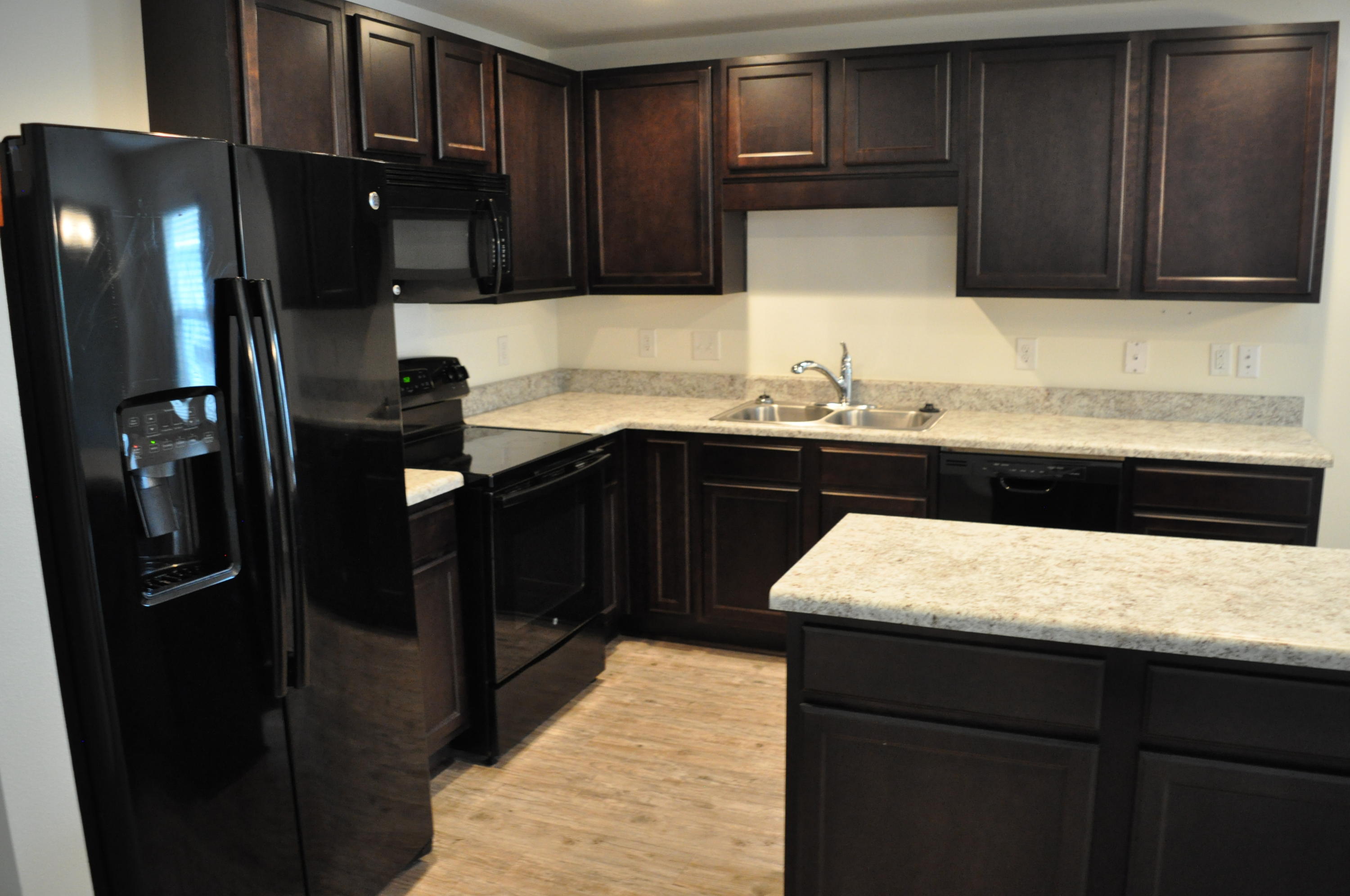 563 Fanny Ann Way Freeport, FL 32439 - Photo 6 of 18 a kitchen with a sink and refrigerator