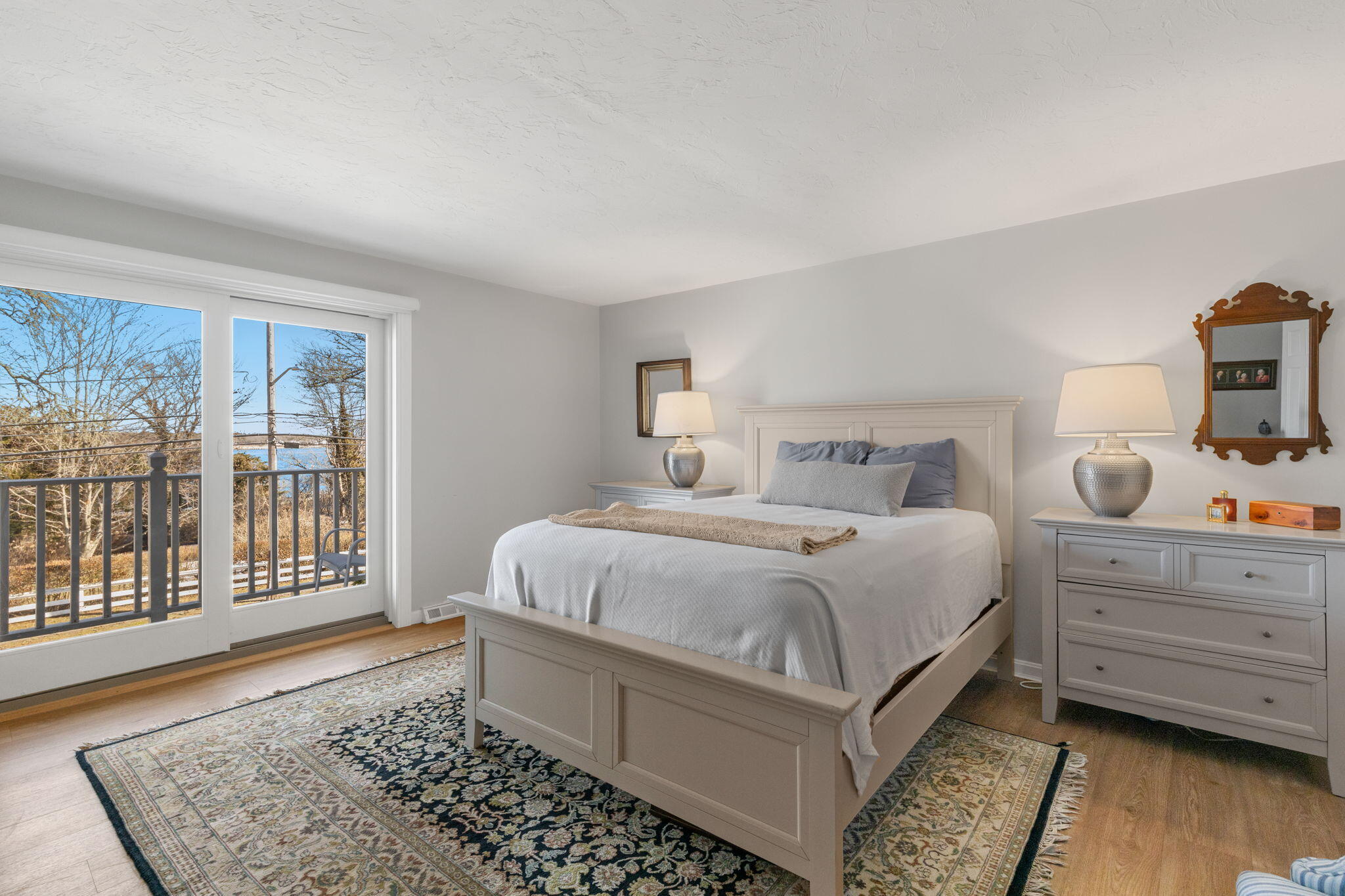 925 Main Street, Unit 3 Cotuit, MA 02635 - Photo 21 of 55 a bedroom with a bed and wooden floor