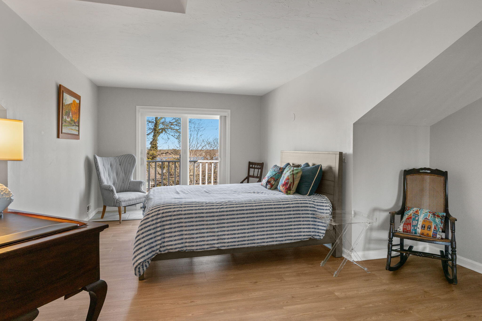 925 Main Street, Unit 3 Cotuit, MA 02635 - Photo 29 of 55 a bedroom with a bed and wooden floor