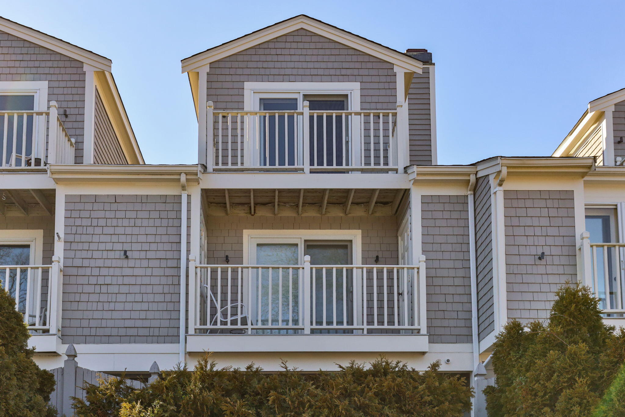 925 Main Street, Unit 3 Cotuit, MA 02635 - Photo 35 of 55 a front view of a house with a fence