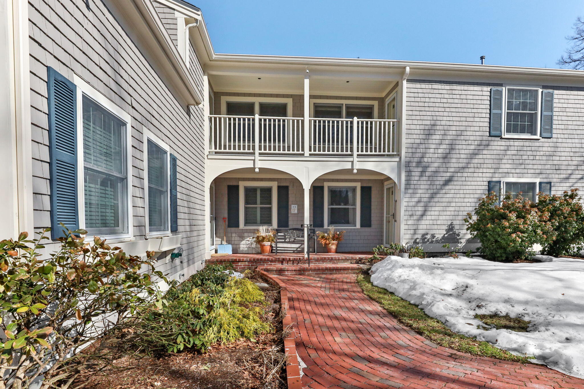 925 Main Street, Unit 3 Cotuit, MA 02635 - Photo 38 of 55 a view of a brick house with many windows