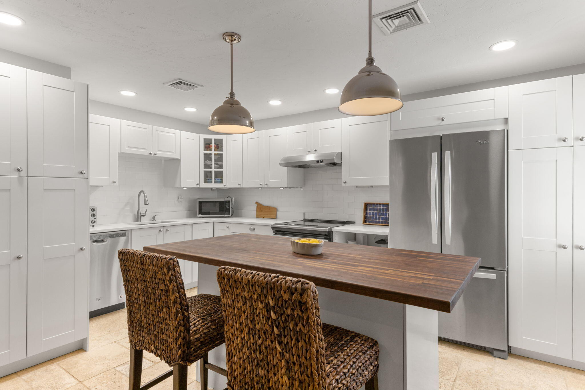 925 Main Street, Unit 3 Cotuit, MA 02635 - Photo 6 of 55 a kitchen with stainless steel appliances granite countertop a stove a refrigerator a sink a center island and chairs