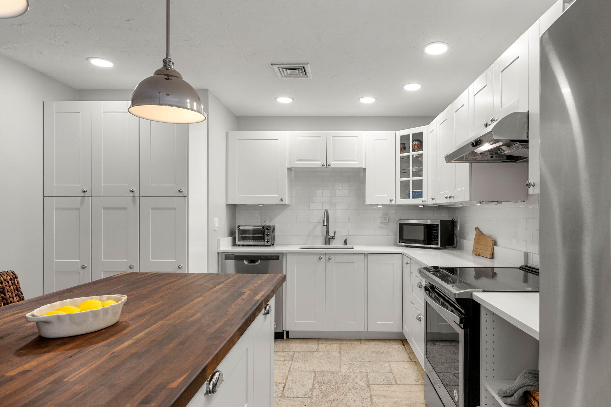 925 Main Street, Unit 3 Cotuit, MA 02635 - Photo 7 of 55 a kitchen with stainless steel appliances granite countertop a sink a stove and cabinets