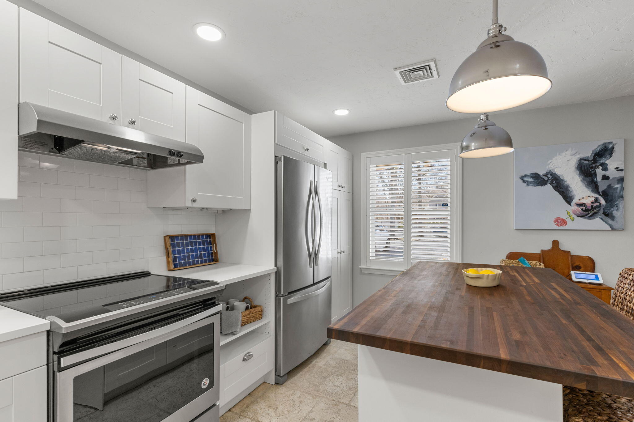 925 Main Street, Unit 3 Cotuit, MA 02635 - Photo 8 of 55 a kitchen with stainless steel appliances granite countertop a sink dishwasher stove and refrigerator with wooden floor