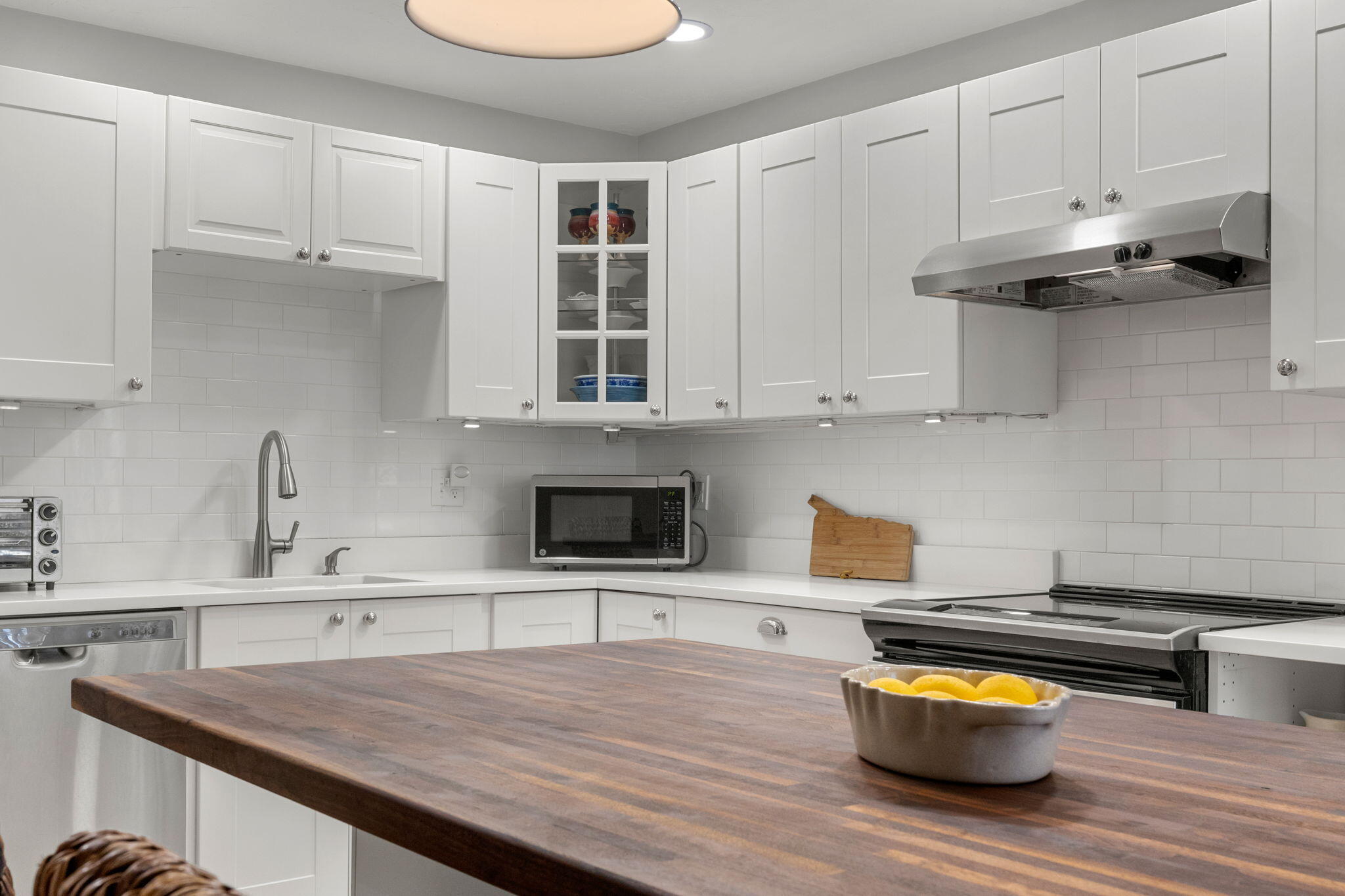 925 Main Street, Unit 3 Cotuit, MA 02635 - Photo 10 of 55 a kitchen with stainless steel appliances granite countertop a sink and a stove