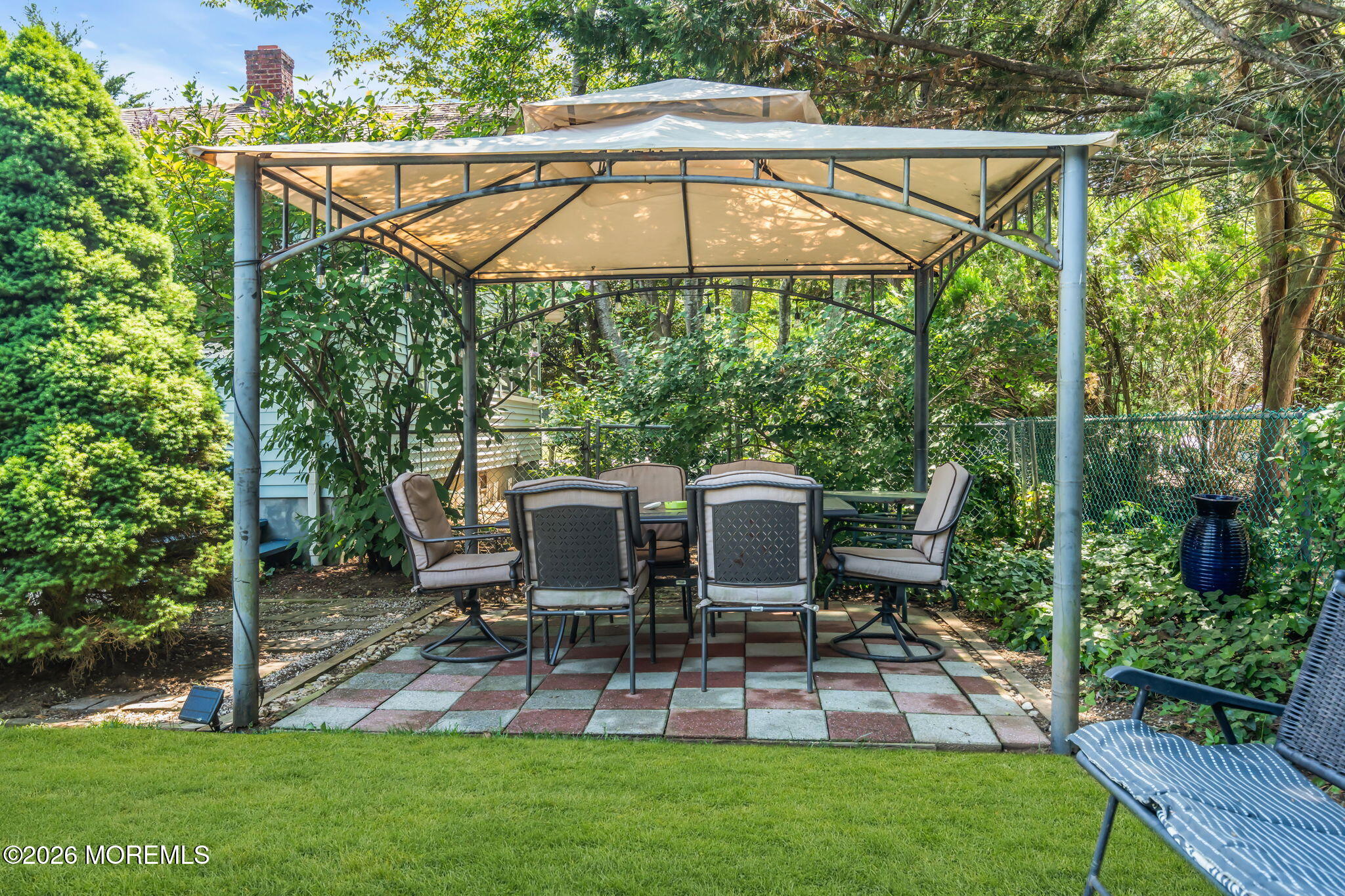24 Foster Street Middletown, NJ 07701 - Photo 18 of 23 a view of a patio with table and chairs under an umbrella
