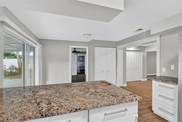 a kitchen with granite countertop wooden cabinets and a counter top space