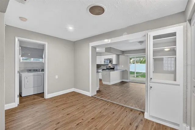 a bedroom with a large bed and a potted plant