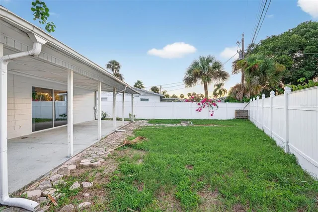 a view of a house with a yard and plants