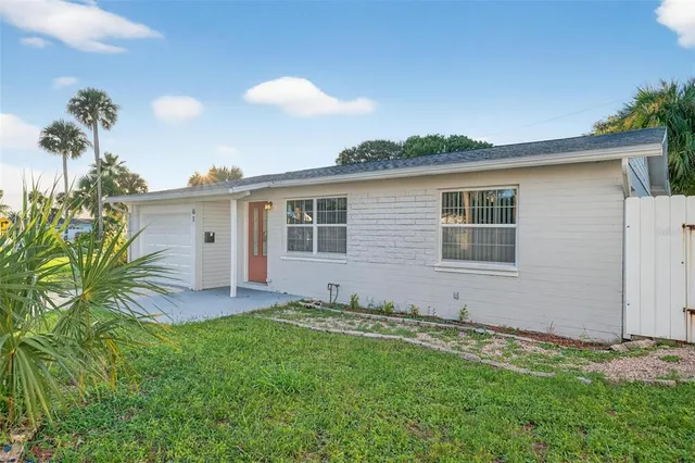 an aerial view of a house with a yard and potted plants