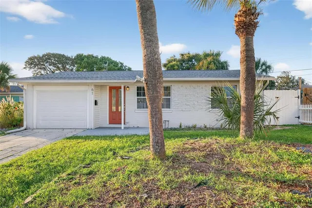 a aerial view of a house with a yard and potted plants