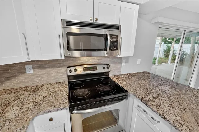 a kitchen with a stove and a microwave