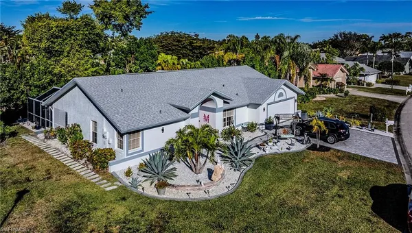 an aerial view of a house with yard swimming pool and outdoor seating