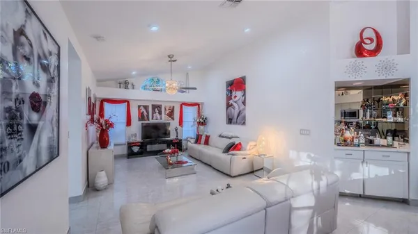 a bedroom with furniture and a flat screen tv