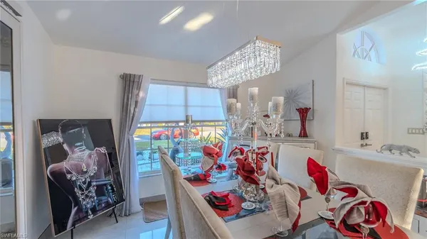 a view of a dining room with furniture and chandelier