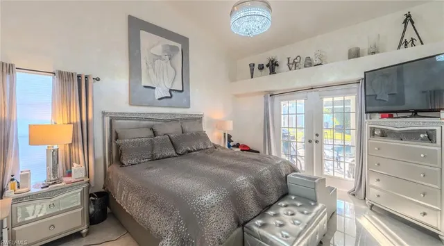 a bedroom with a bed and a television in it