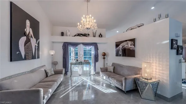 a living room with furniture and a chandelier