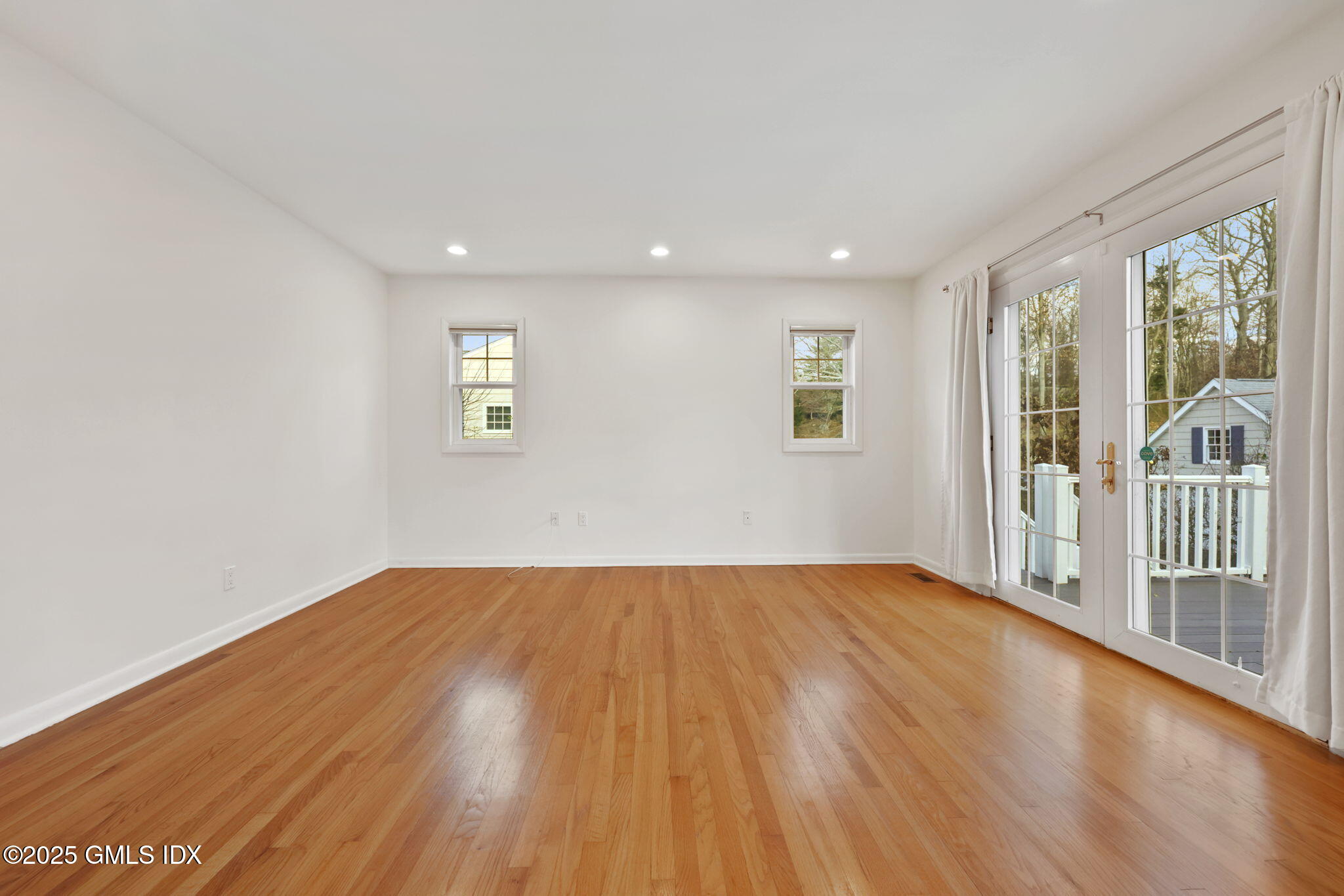 53 Midbrook Lane Old Greenwich, CT 06870 - Photo 11 of 39 a view of an empty room with wooden floor and a window