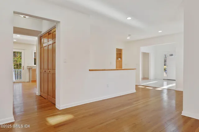 a view of empty room with wooden floor