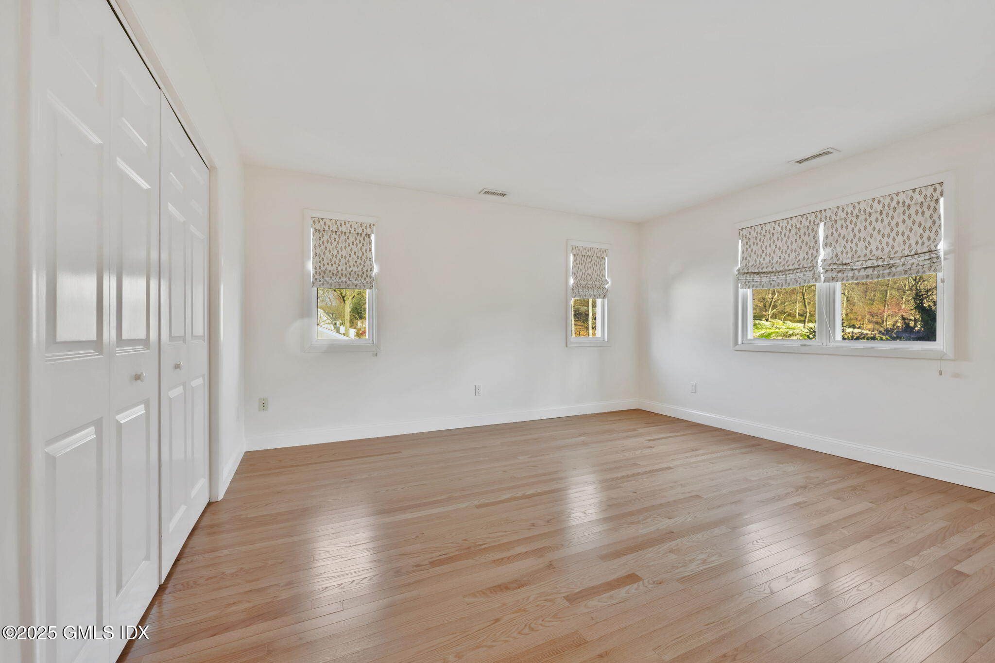 53 Midbrook Lane Old Greenwich, CT 06870 - Photo 16 of 39 a view of an empty room with wooden floor and a window