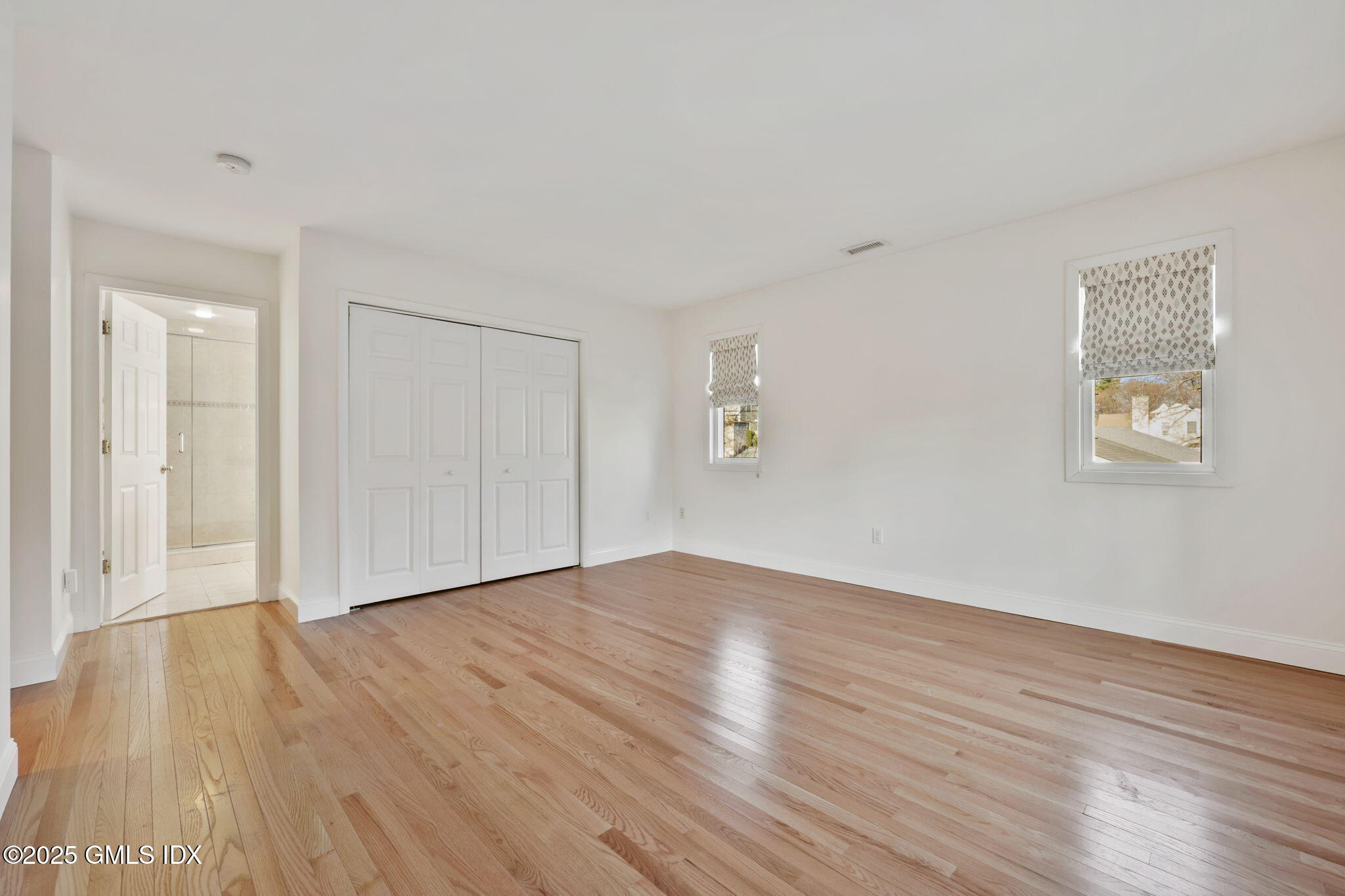 53 Midbrook Lane Old Greenwich, CT 06870 - Photo 17 of 39 a view of an empty room with wooden floor and a window
