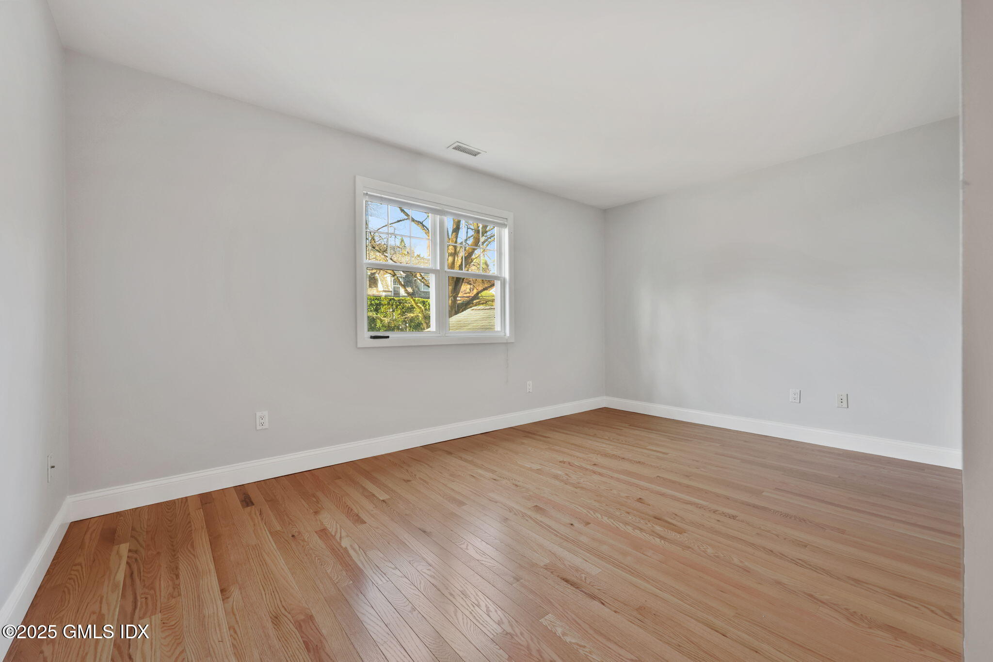 53 Midbrook Lane Old Greenwich, CT 06870 - Photo 23 of 39 an empty room with wooden floor and windows